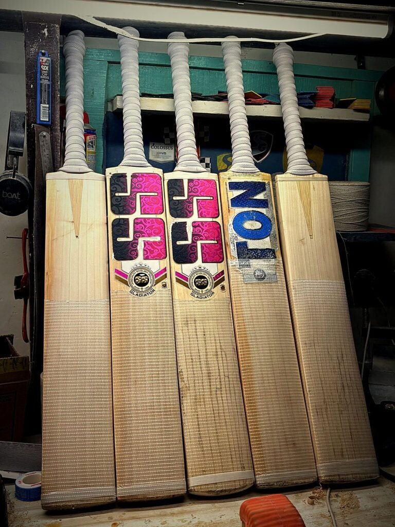 Cricket bats with new handles and grips, ready for pickup at Cricfix