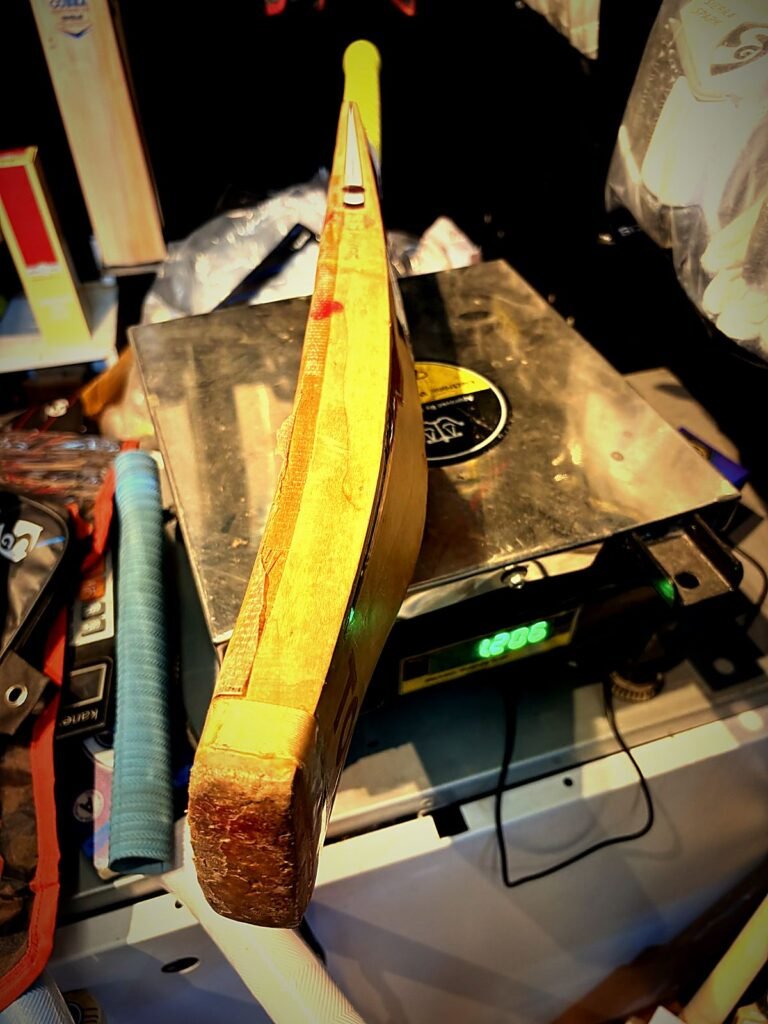 Weighing a cricket bat during weight reduction at Cricfix